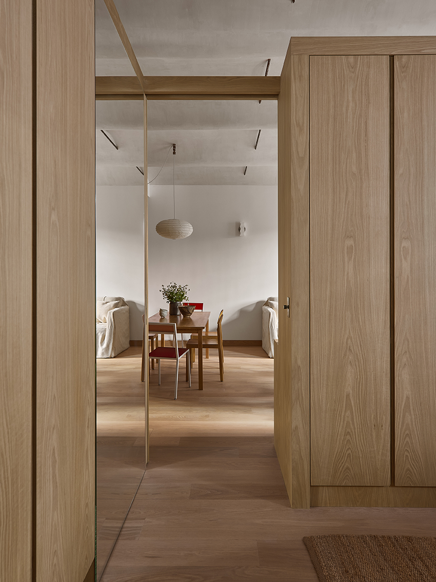 Open apartment organized around custom white oak millwork volumes