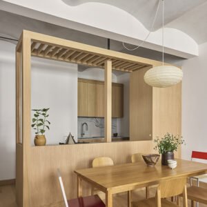 Kitchen integrated into white oak millwork with slatted enclosure